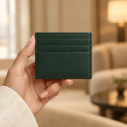 Forest-green ALTAIR cardholder being carried, with the ALTAIR logo visible